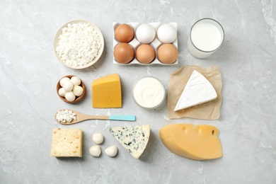 Different dairy products on marble table, flat lay