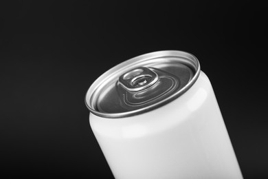 Photo of White can of energy drink on black background, closeup. Space for text