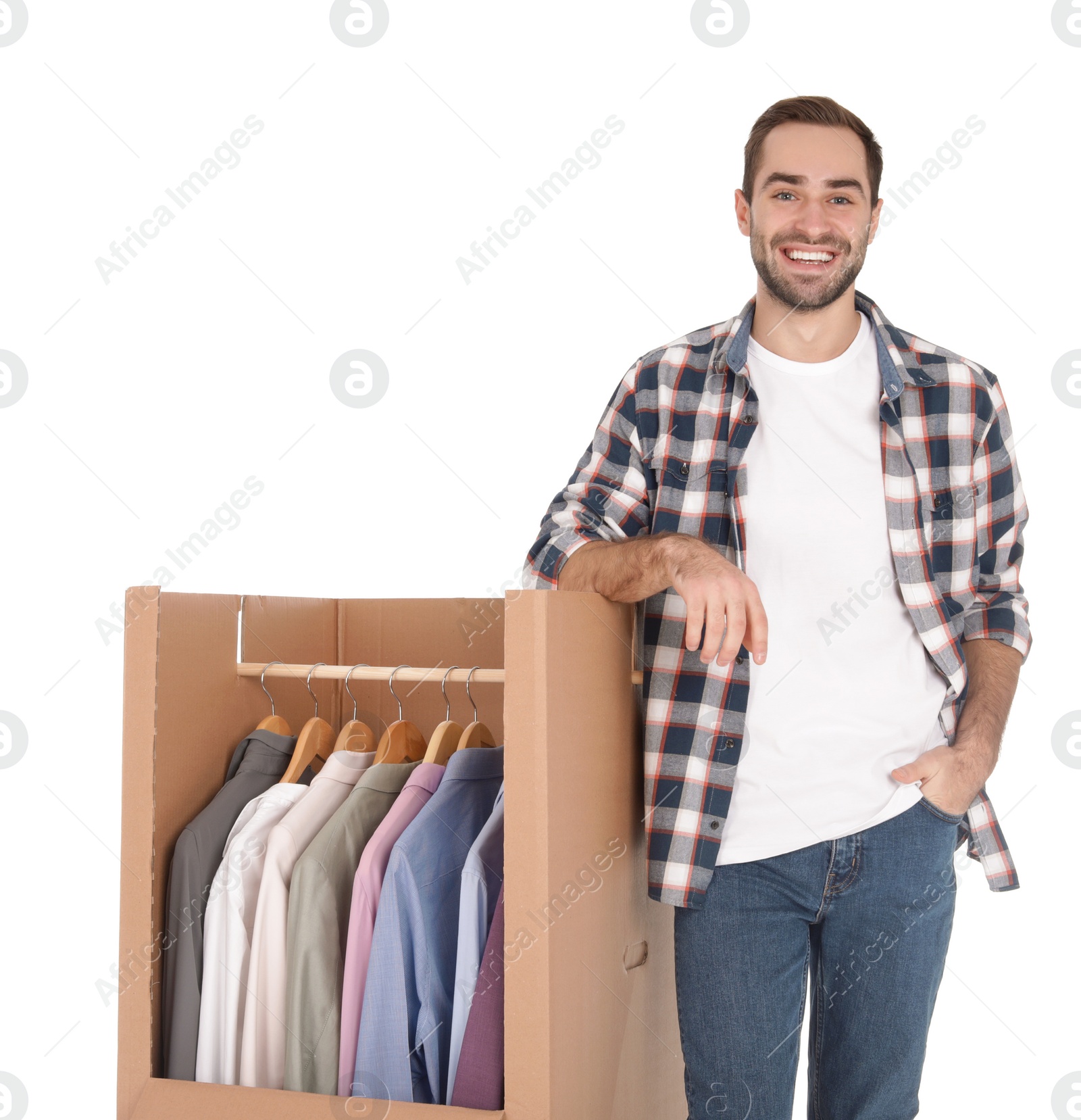 Photo of Young man near wardrobe box on white background