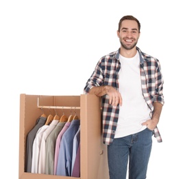 Young man near wardrobe box on white background