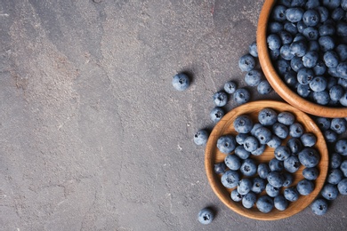 Photo of Flat lay composition with juicy blueberries and space for text on color table