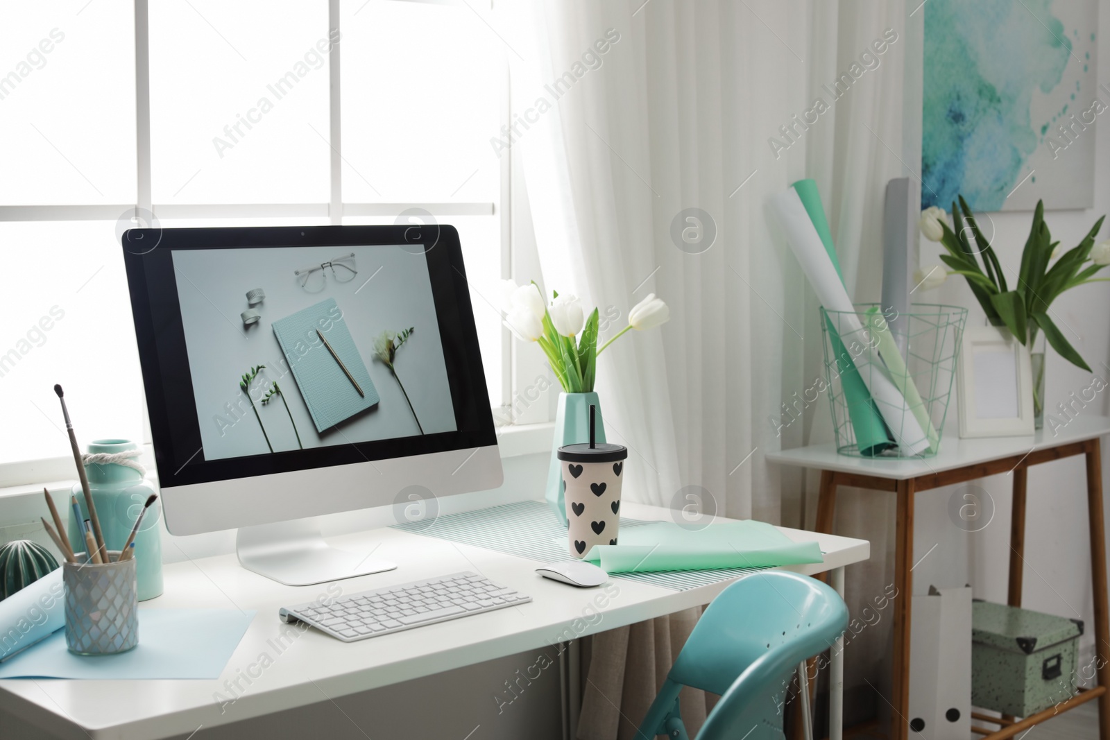 Photo of Stylish workplace interior with modern computer on desk