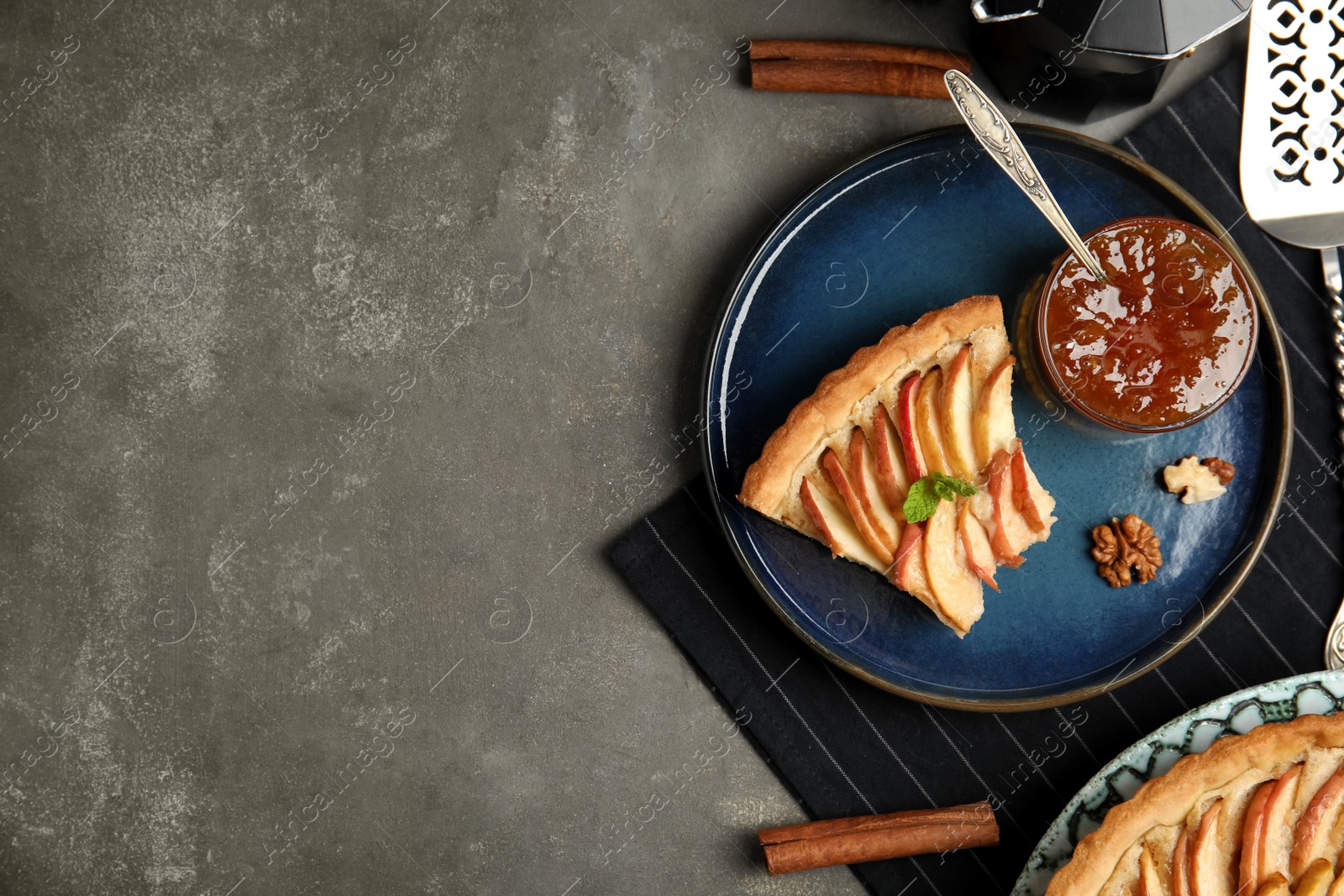 Photo of Delicious apple pie served on grey table, flat lay. Space for text