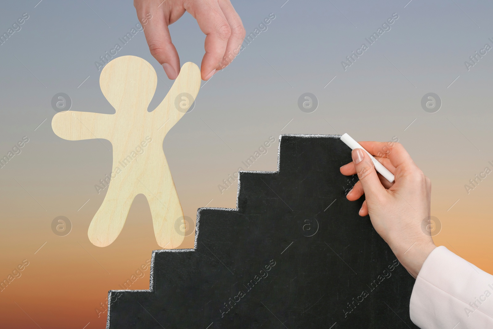 Image of Steps to success. Wooden human figure climbing up stairs with help of man. Woman drawing staircase on chalkboard, closeup