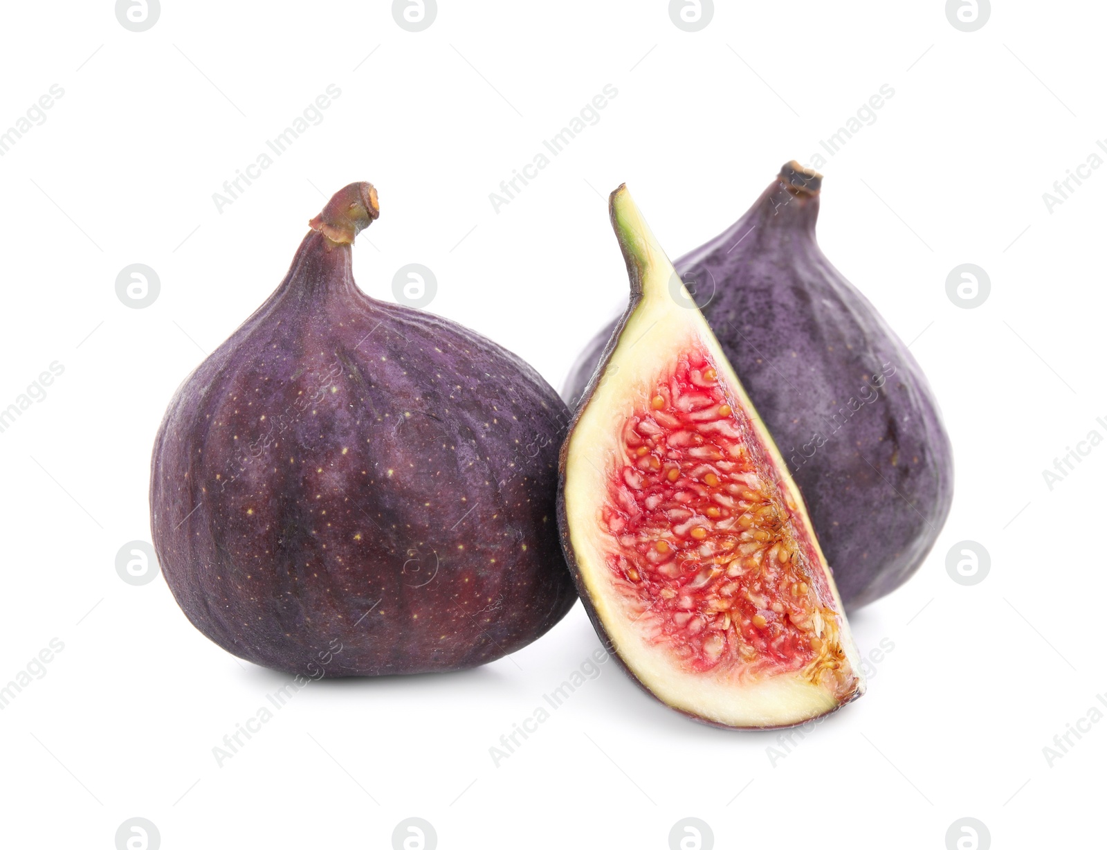 Photo of Whole and cut fresh ripe figs isolated on white