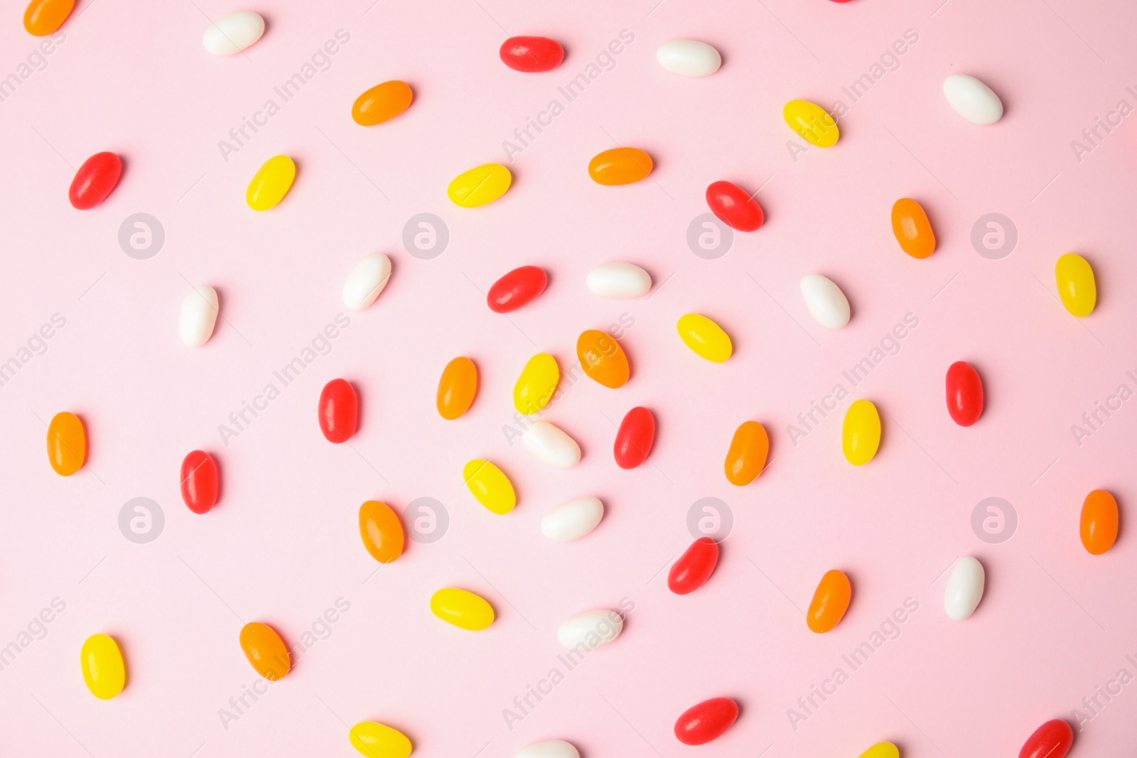 Photo of Flat lay composition with jelly beans on color background