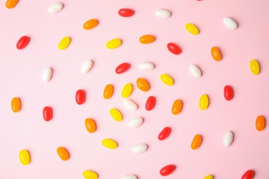 Photo of Flat lay composition with jelly beans on color background