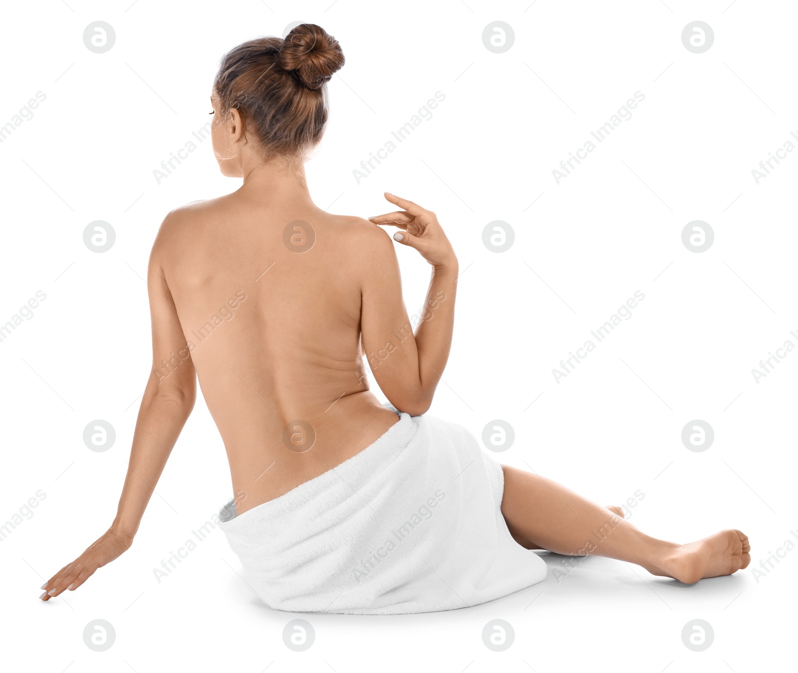 Photo of Young woman with soft towel sitting on white background