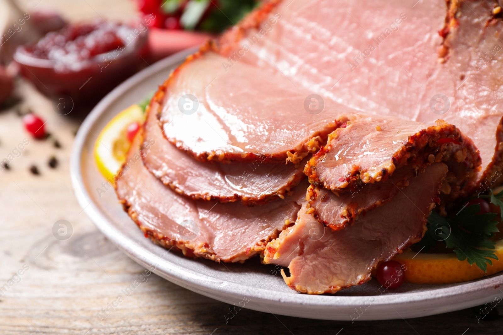 Photo of Delicious ham served with garnish on wooden table, closeup