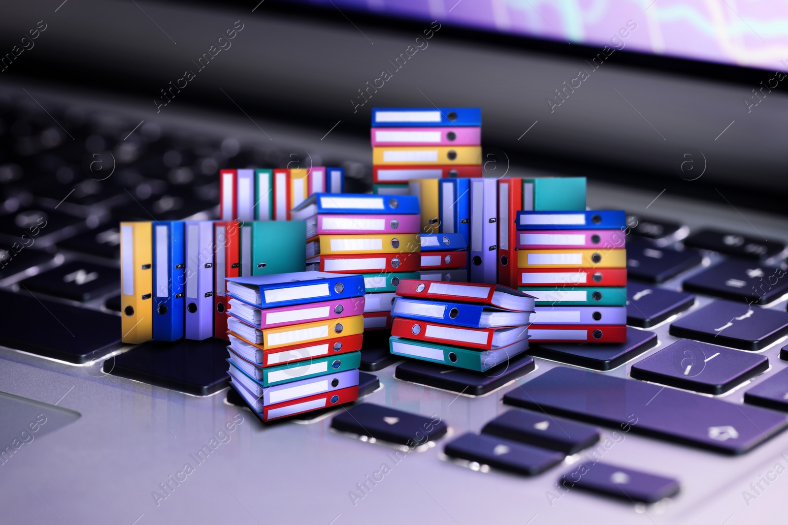 Image of Digital archive. Laptop keyboard with many downsized folders, closeup