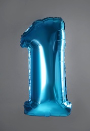 Photo of Blue number one balloon on grey background