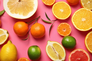 Photo of Different citrus fruits on color background, top view