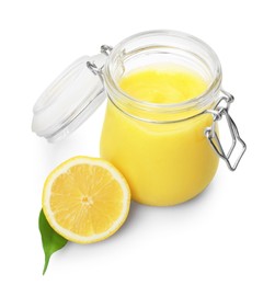 Photo of Delicious lemon curd in glass jar, fresh citrus fruit and green leaf isolated on white