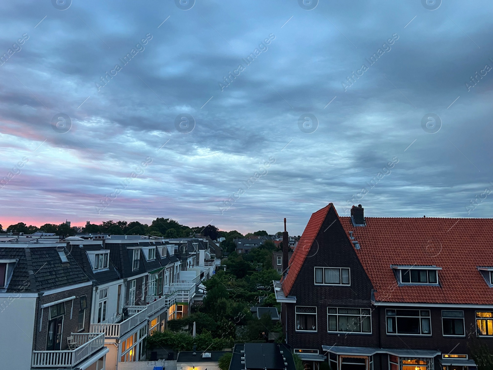 Photo of Picturesque view of city street with beautiful buildings at sunrise