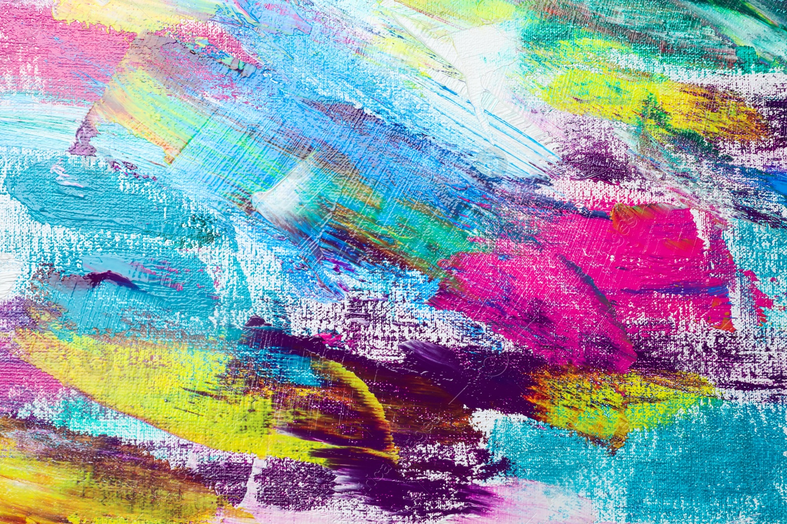 Photo of Strokes of colorful acrylic paints on canvas, closeup