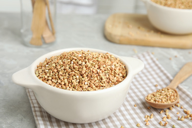 Photo of Organic green buckwheat on marble table. Healthy food