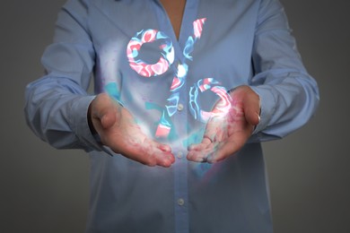 Image of Discount offer. Woman holding illustration of percent sign on grey background, closeup