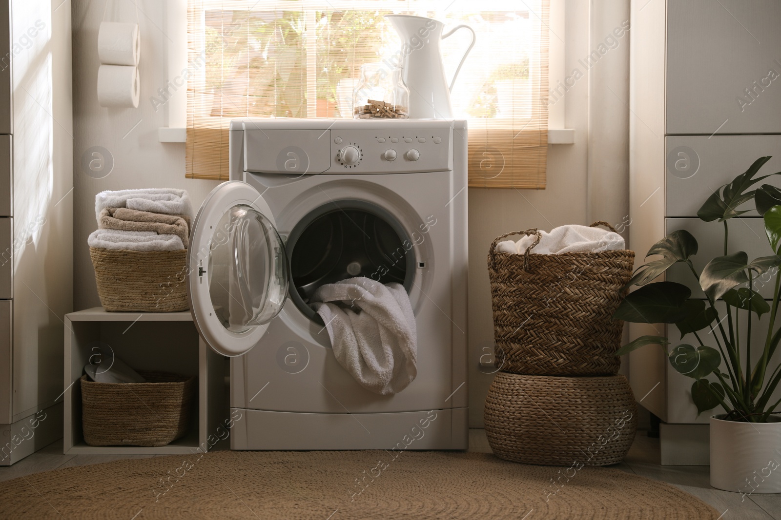 Photo of Stylish room interior with washing machine. Design idea