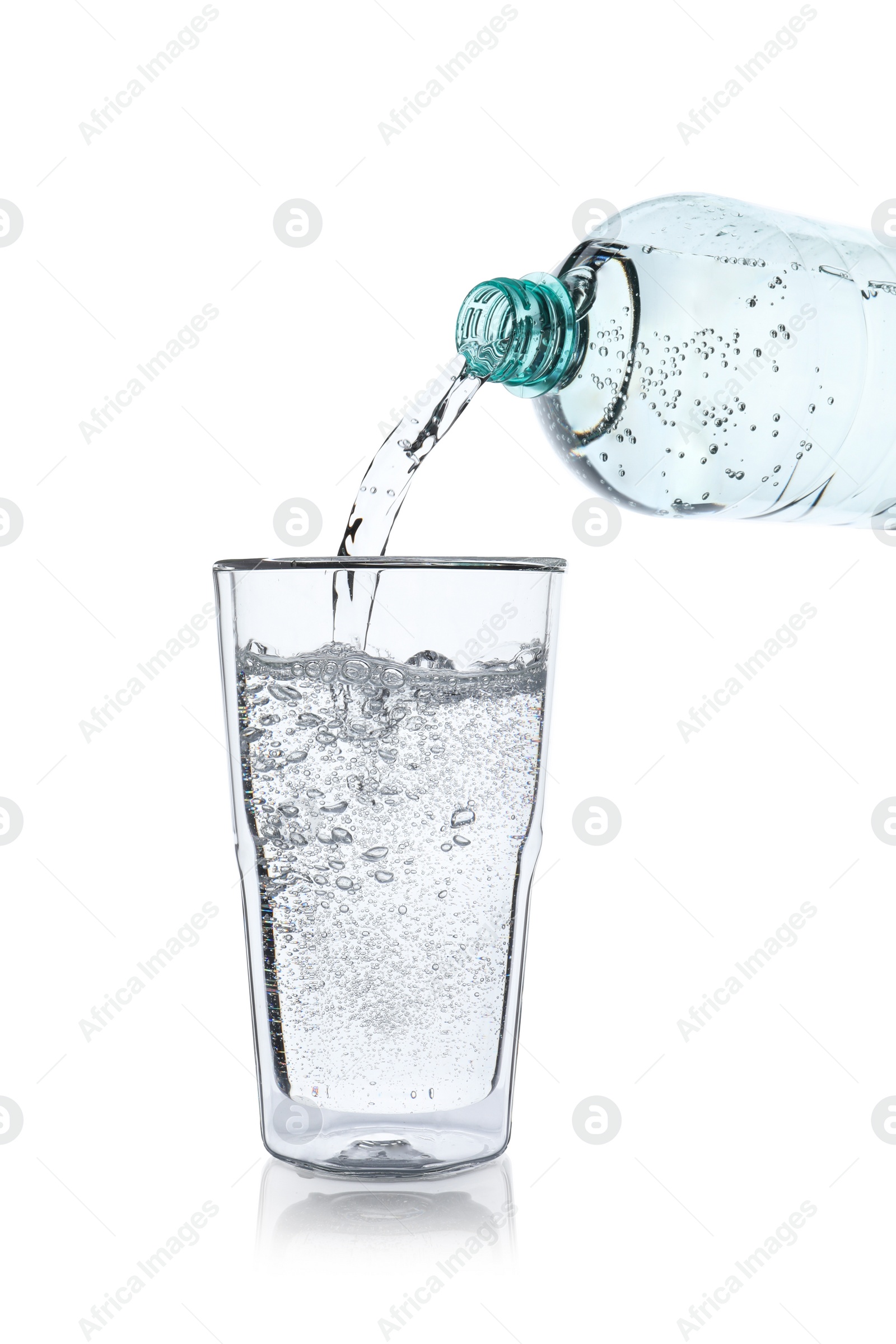 Photo of Pouring soda water from bottle into glass on white background