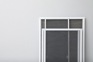 Photo of Set of window screens on light grey background. Space for text