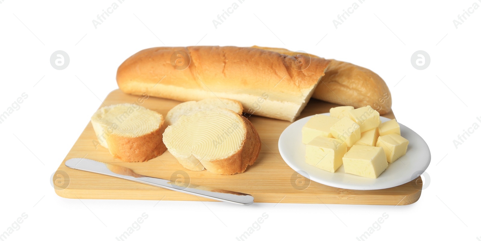 Photo of Whole and cut baguettes with fresh butter on white background