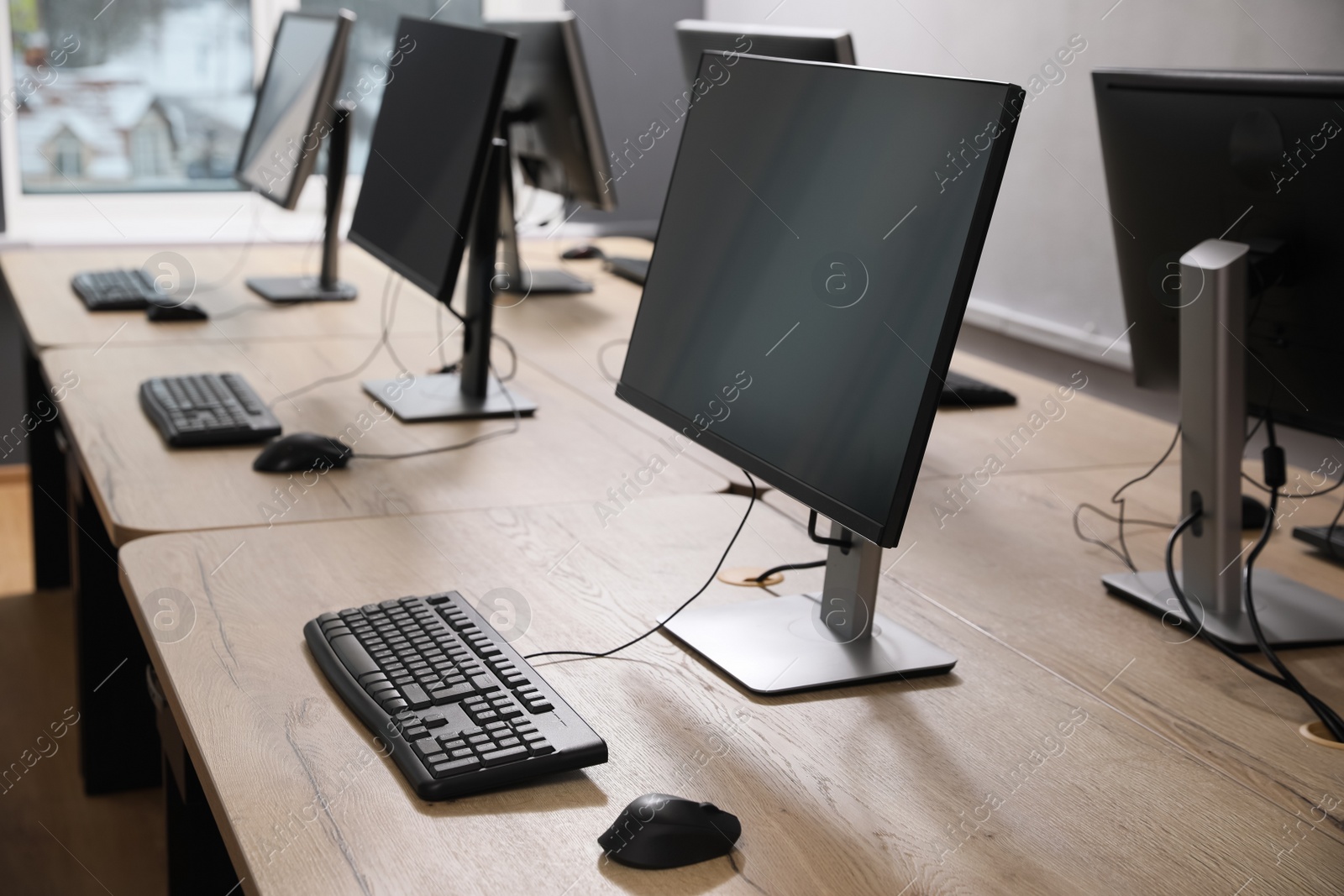 Photo of Many modern computers in open space office