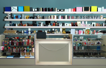 Counter and shelves with perfume bottles in shop