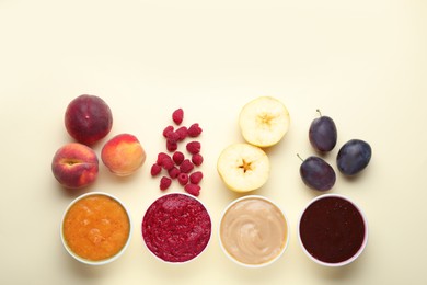 Photo of Different puree in bowls and fresh ingredients on beige background, flat lay