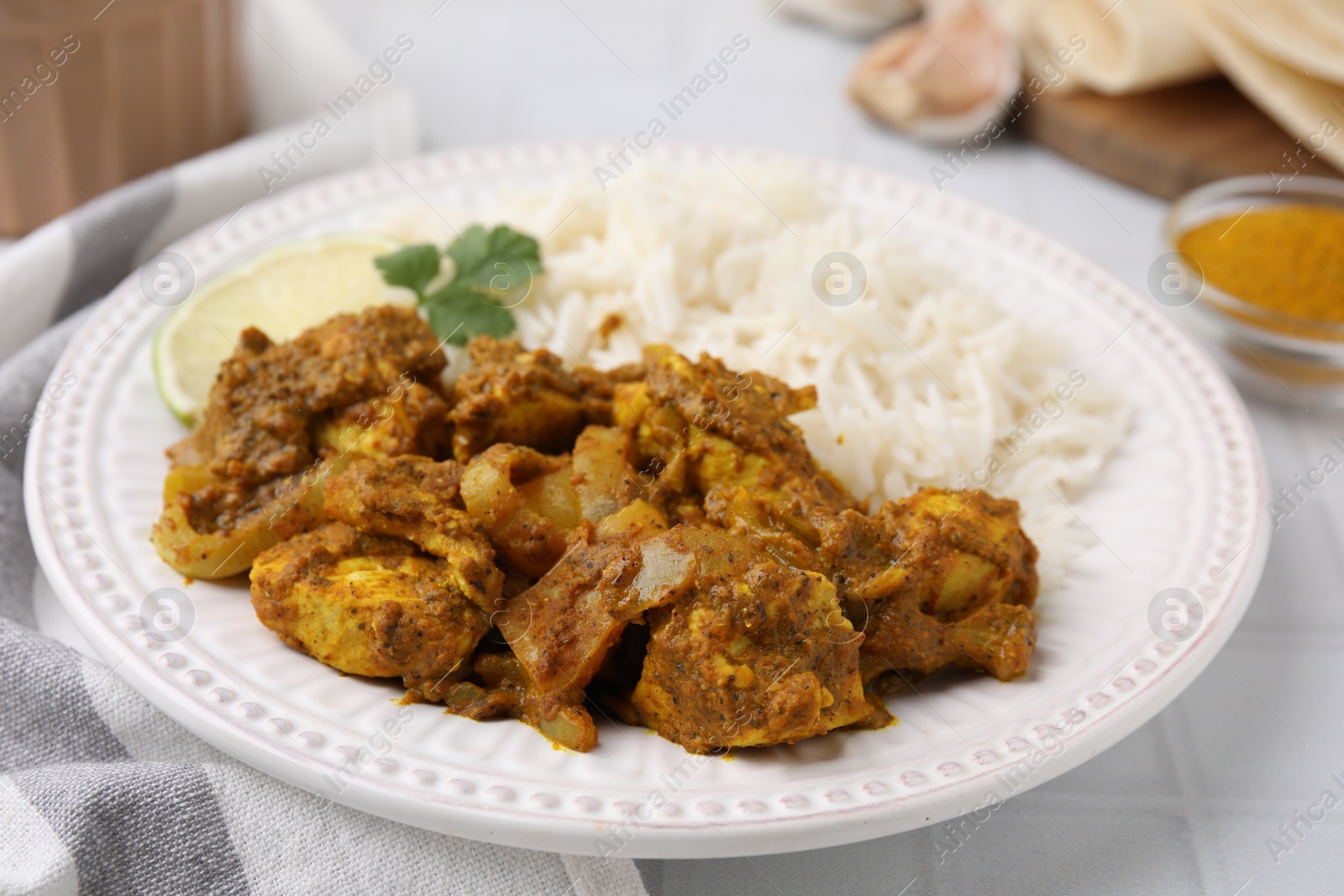 Photo of Delicious chicken curry with rice on table, closeup