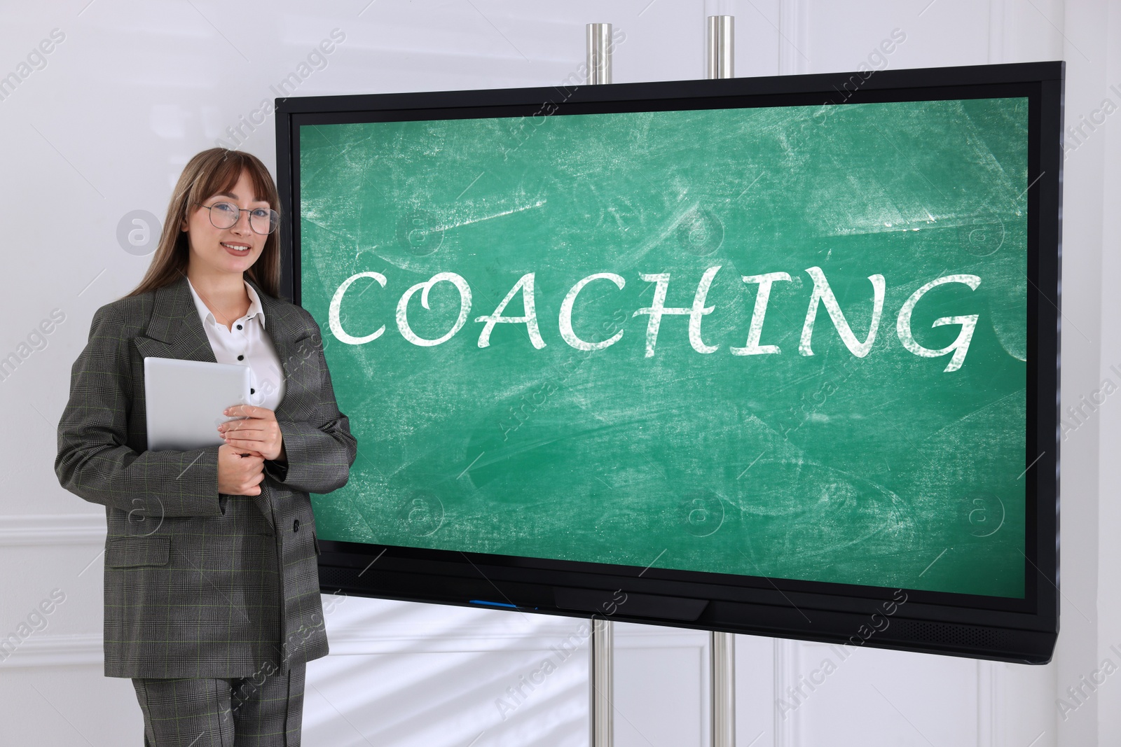 Photo of Business trainer near interactive board in meeting room