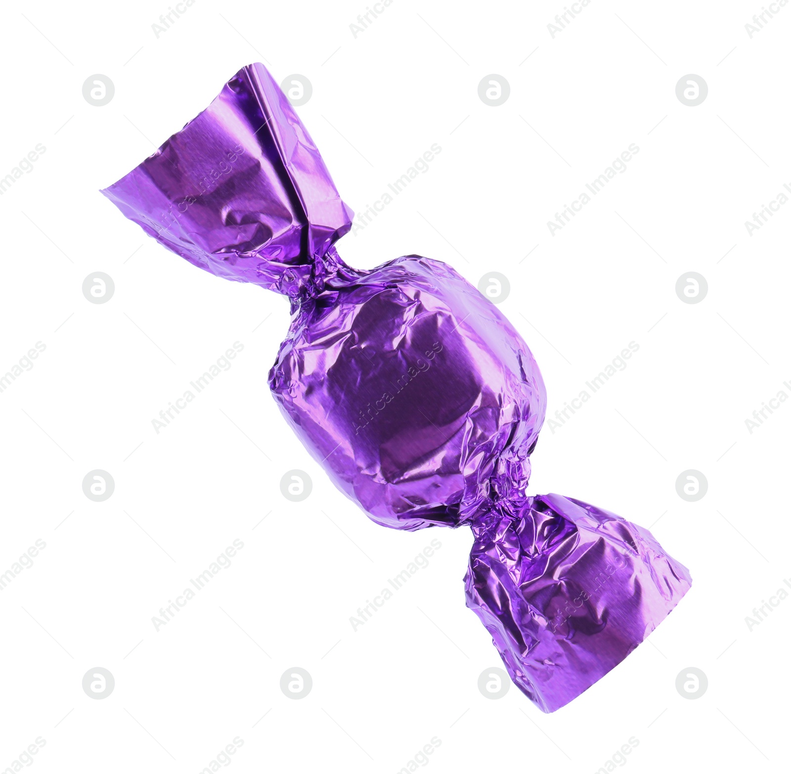 Photo of Tasty candy in purple wrapper isolated on white