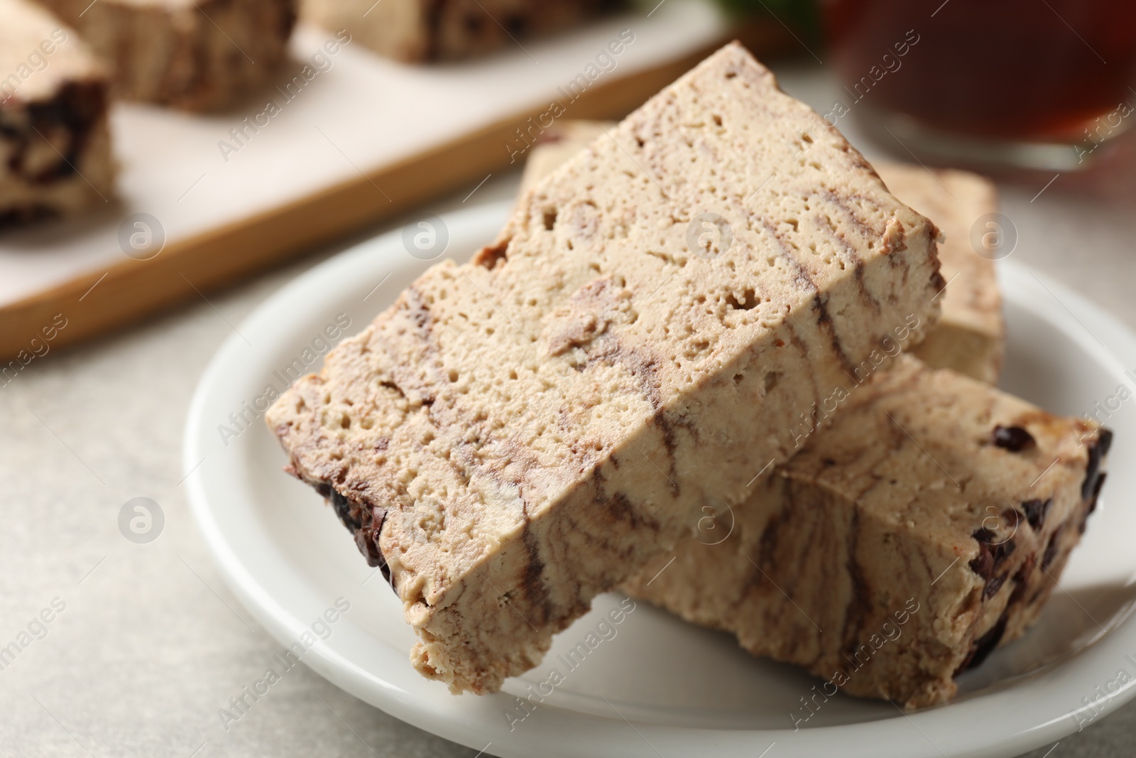 Photo of Tasty chocolate halva on grey table, closeup