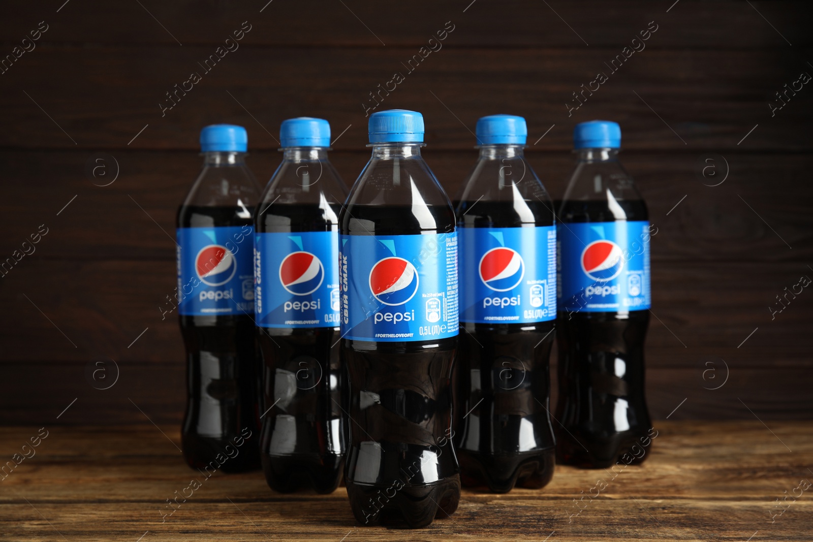 Photo of MYKOLAIV, UKRAINE - FEBRUARY 10, 2021: Bottles of Pepsi on wooden table