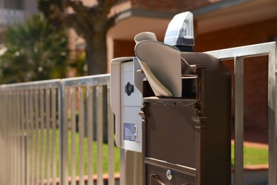 Photo of Mailbox with newspaper near house outdoors on sunny day, space for text