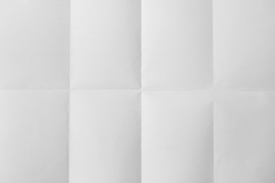 Sheet of folded white paper as background, top view