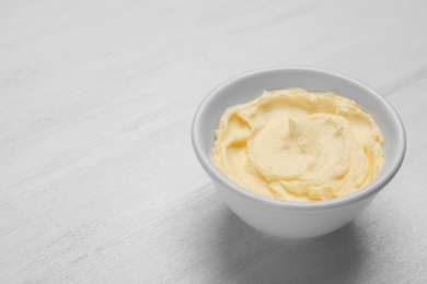 Photo of Bowl with tasty fresh butter on table