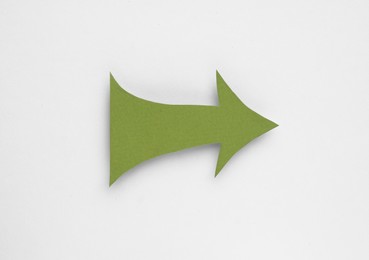 Photo of Paper arrow on white background, top view