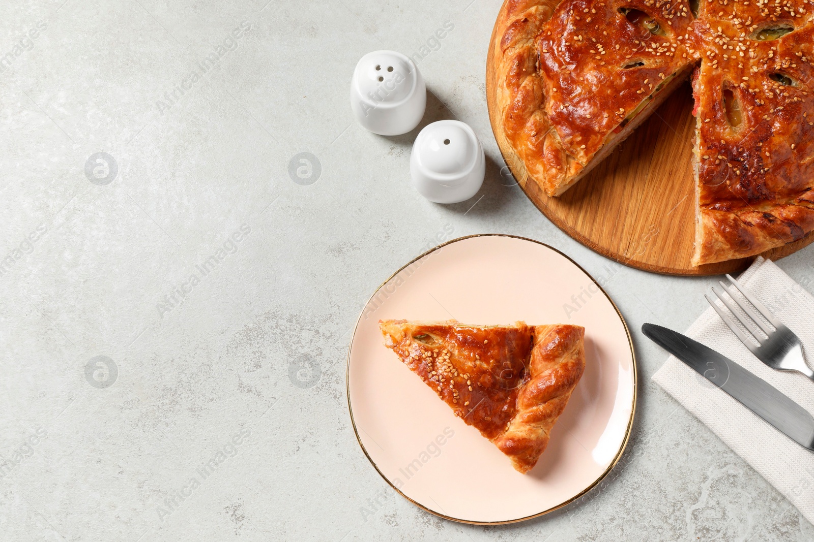 Photo of Tasty homemade pie served on light grey table, flat lay. Space for text