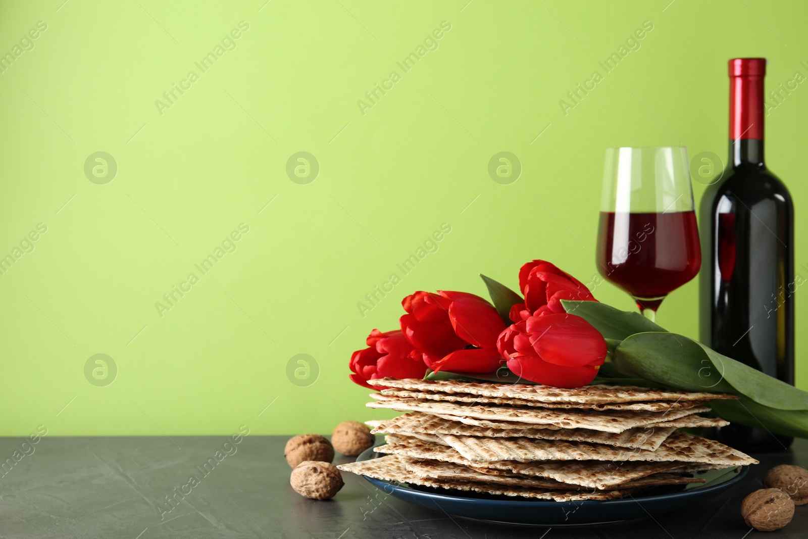 Photo of Composition with Passover matzos on green background, space for text. Pesach celebration