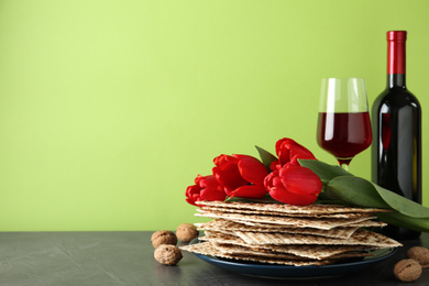 Photo of Composition with Passover matzos on green background, space for text. Pesach celebration