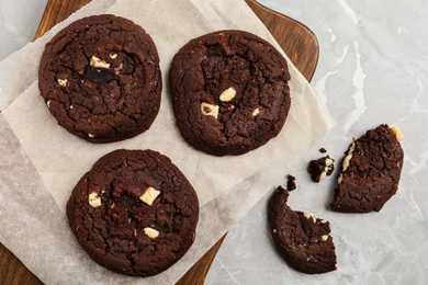 Photo of Delicious chocolate cookies on marble table, flat lay