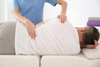 Photo of Doctor working with patient in hospital. Rehabilitation massage