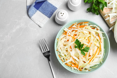 Photo of Flat lay composition with cabbage salad on light grey marble table