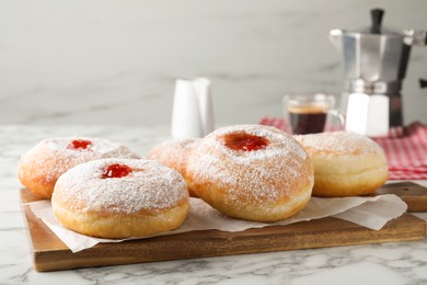 Delicious donuts with jam and powdered sugar on white marble table. Space for text