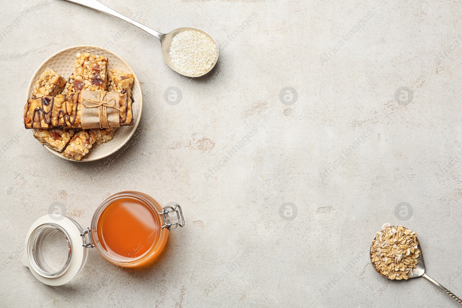 Photo of Flat lay composition with grain cereal bars and honey on table. Healthy snack