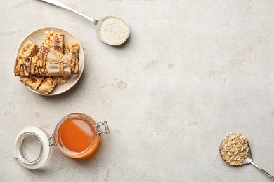 Flat lay composition with grain cereal bars and honey on table. Healthy snack