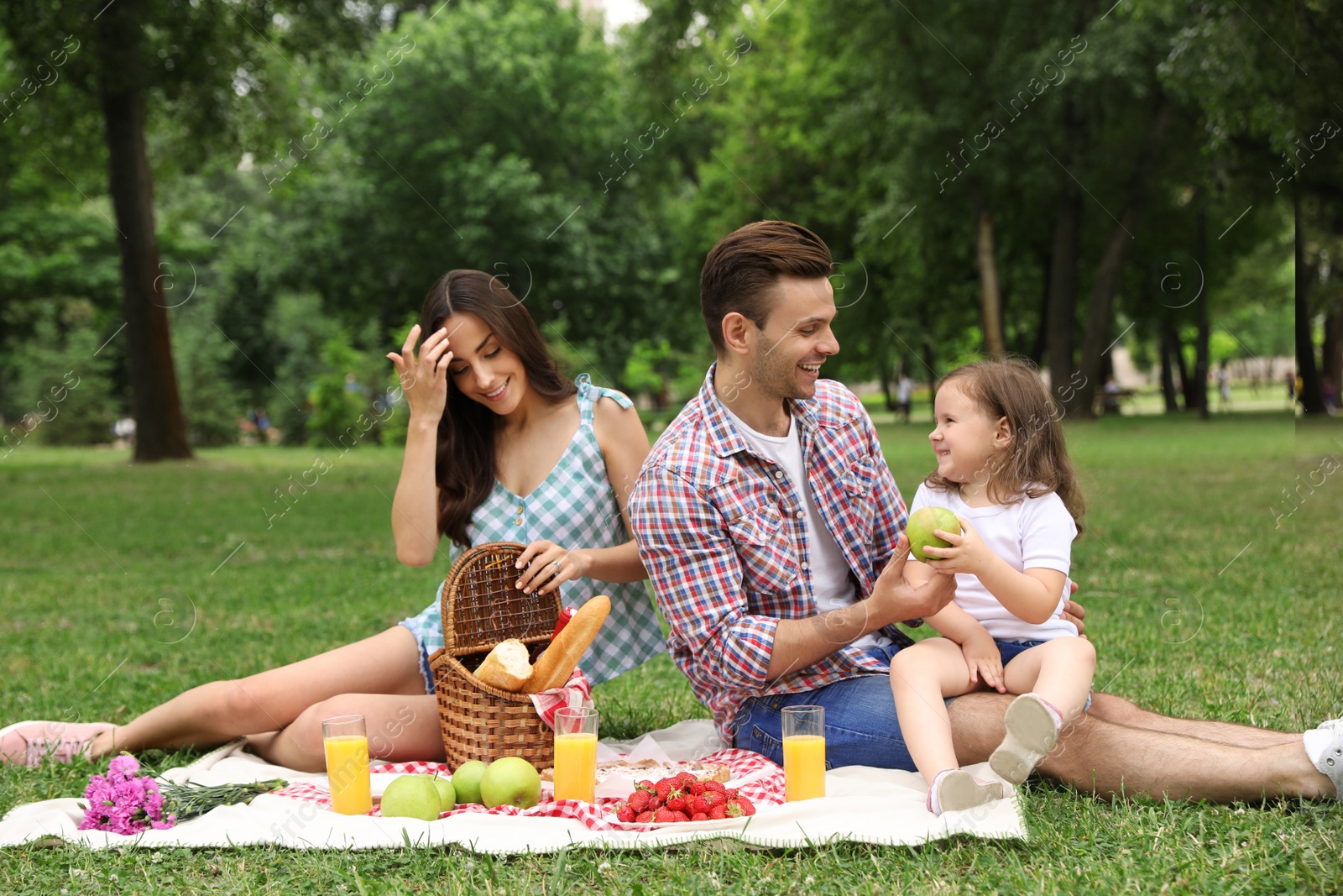 Photo of Happy family having picnic in park on summer day