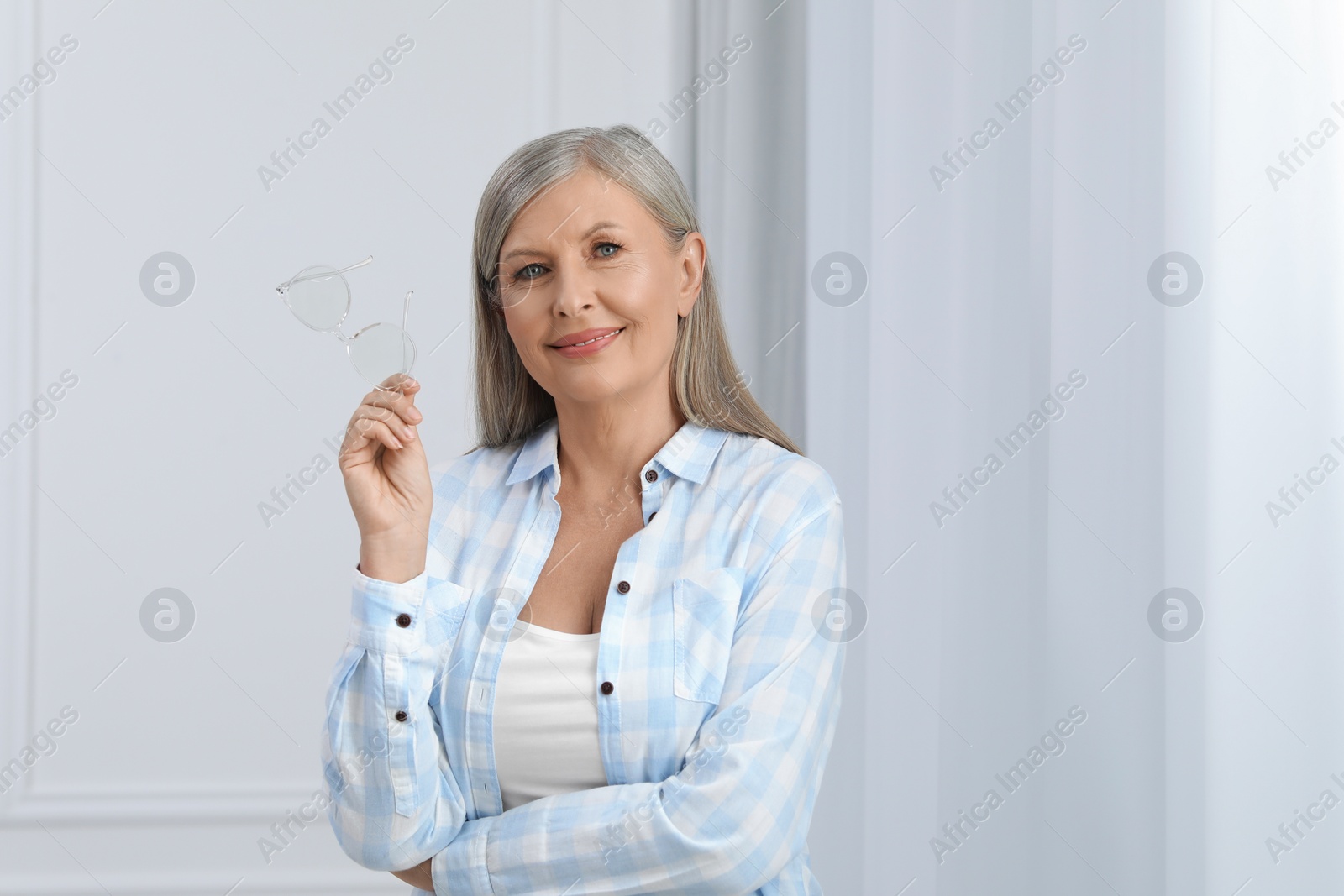 Photo of Portrait of beautiful senior woman with gray hair indoors