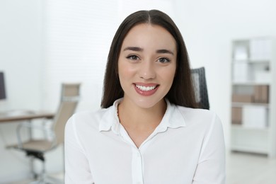 Portrait of beautiful young woman in office