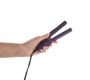 Woman holding modern hair iron on white background, closeup